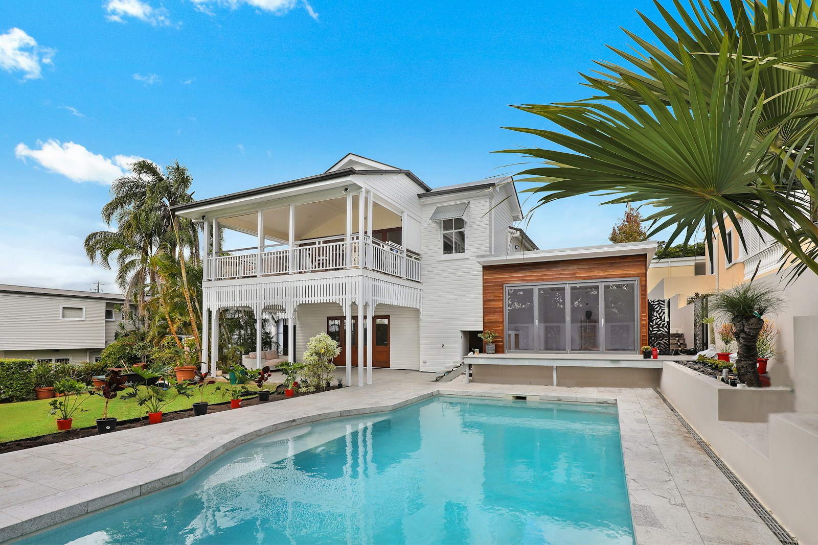 Illustrative stock photo of a house under trees with a visible roof, not a company office or a specific job